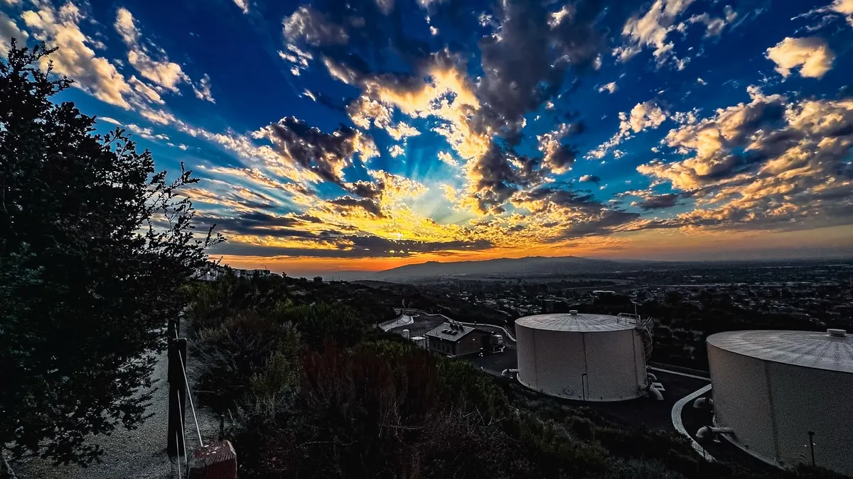 Sunset over the basin from the ridge, the water tanks below.
